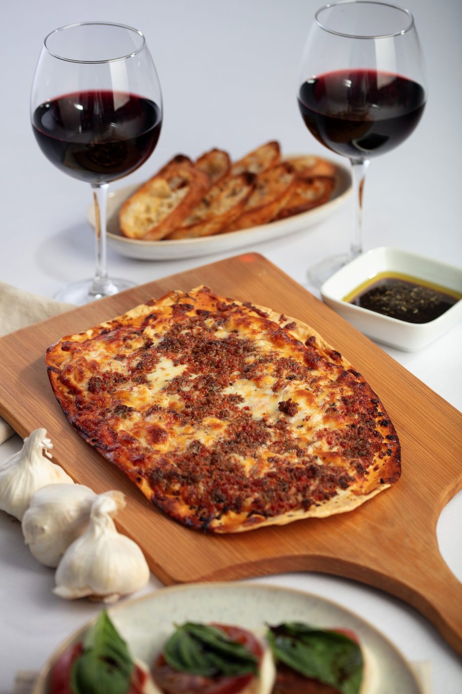 Uncle's thin crust pepperoni pizza on a wooden board